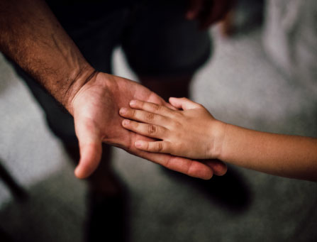 adult and child holding hands